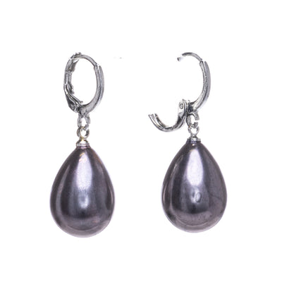 Droplet-shaped pearl earrings hanging from a ring