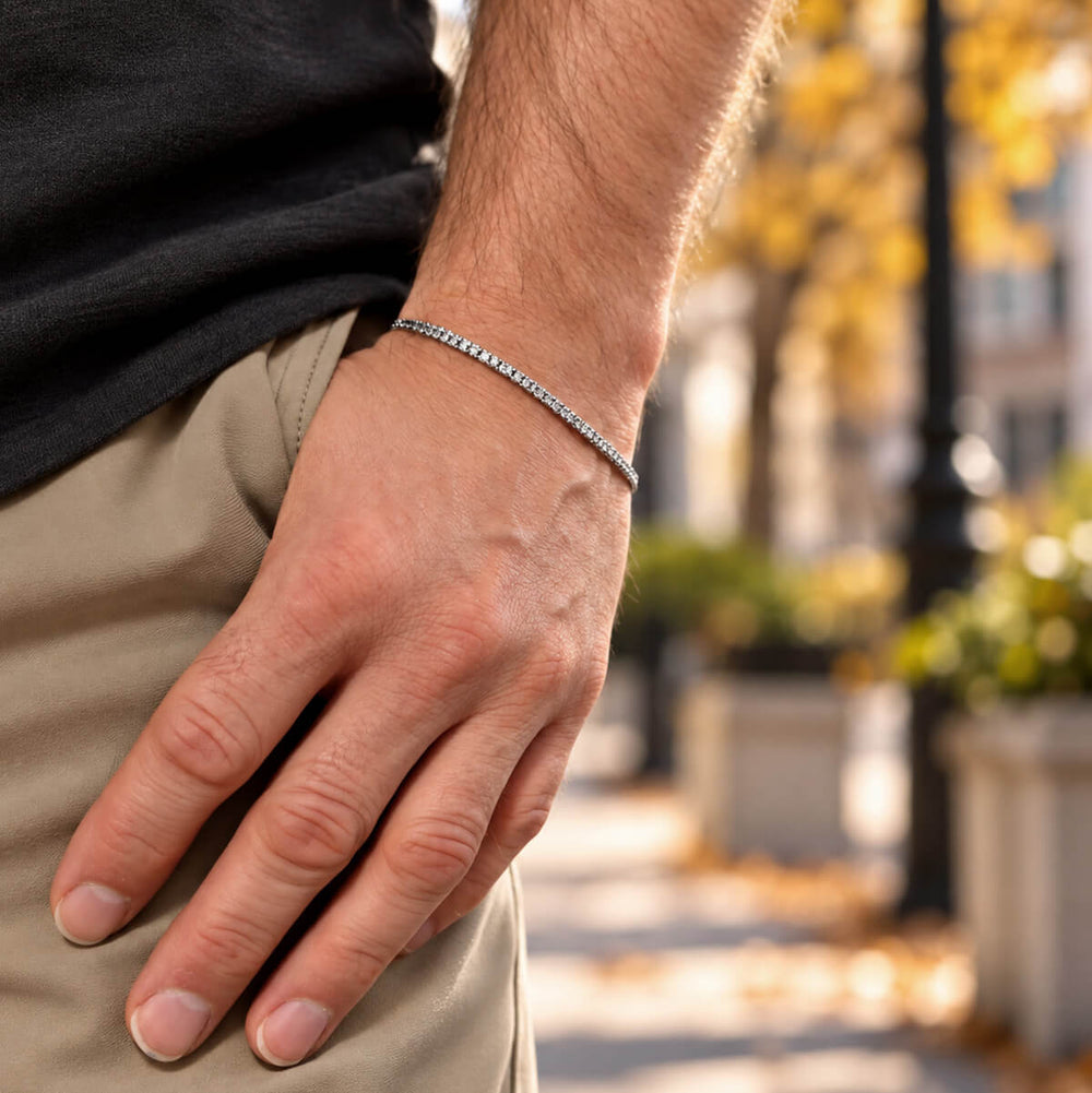 A thin men's steel bracelet on the wrist