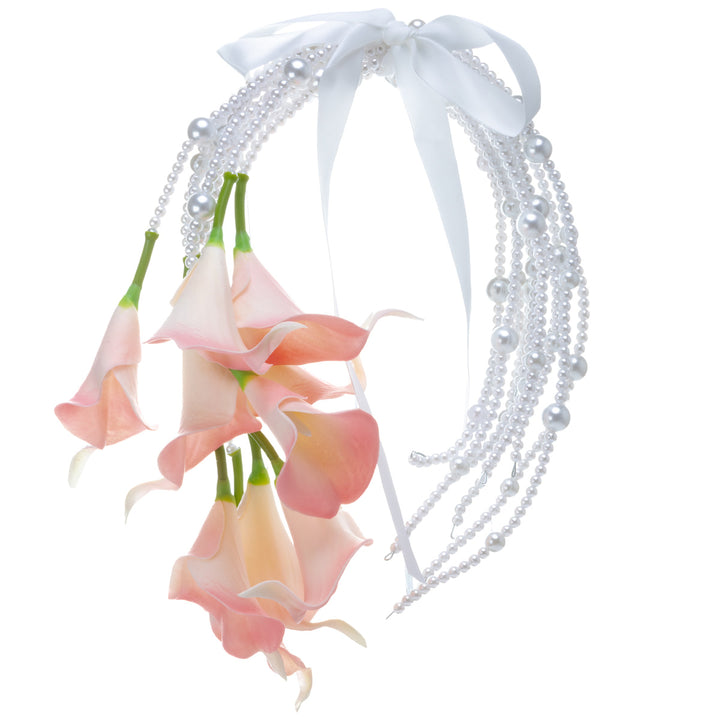 A calla lily bridal bouquet with a peach-colored artificial flower