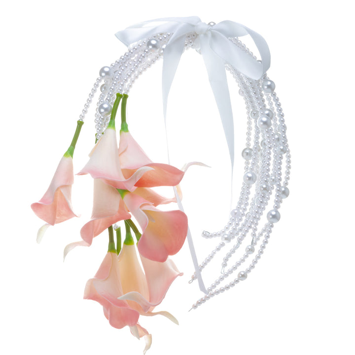 A calla lily bridal bouquet with a peach-colored artificial flower