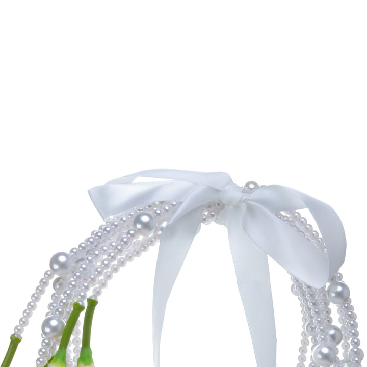 A calla lily bridal bouquet with a peach-colored artificial flower