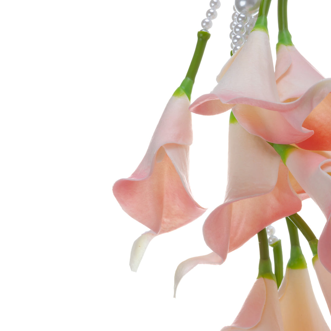 A calla lily bridal bouquet with a peach-colored artificial flower