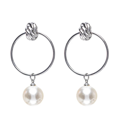 A pearl earrings hanging from the tire